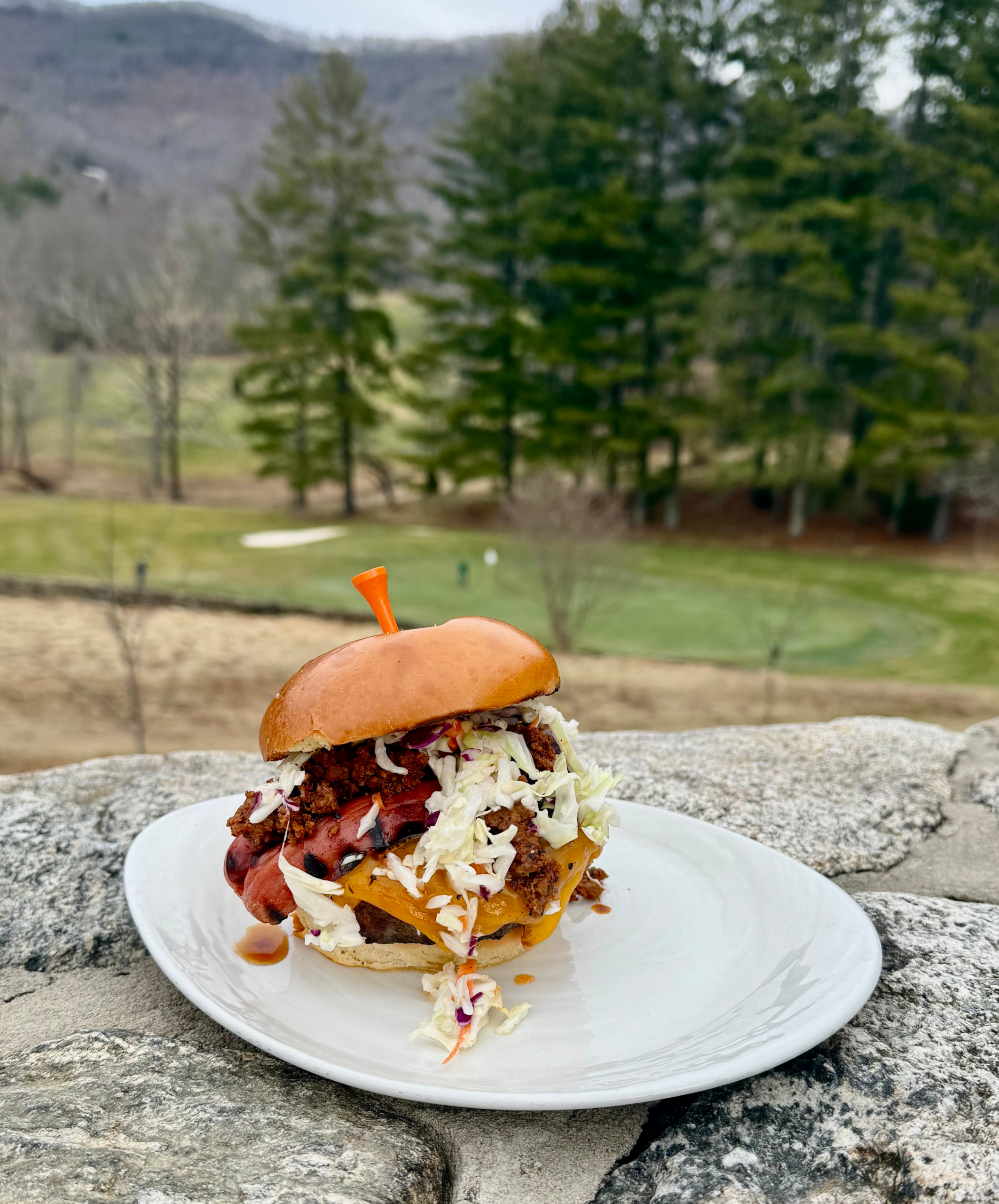 The Triple Bogey Burger, held together by a tee-shaped skewer, overlooks the golf green at Springdale Resort, home to Rocky Face Tavern.