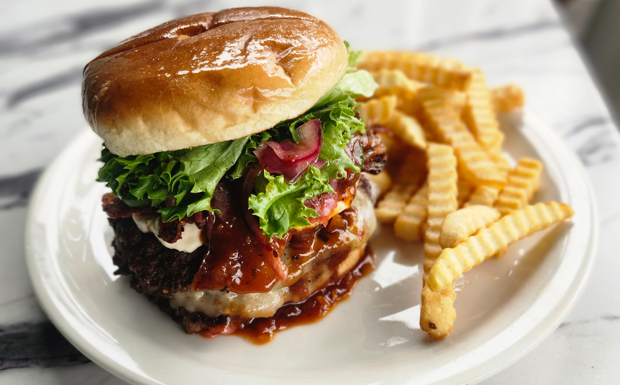 A brightly-lit photo of Waynesville Main Street Diner's "Smoky Mountain Bacon Bliss Burger."